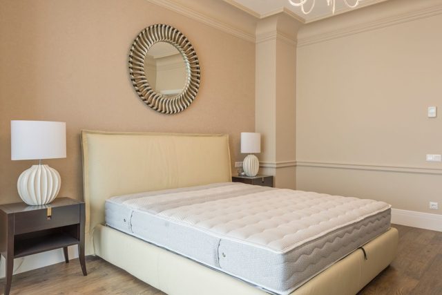 Mattress on a bed in a bright bedroom
