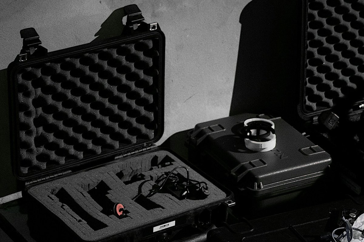 Open hard case with an egg-crate foam lid and cut-out foam inside